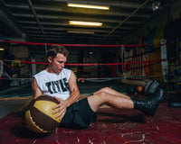 variantl:lifestyle::TITLE Boxing Retro Leather Medicine Balls  guy left  and right ball