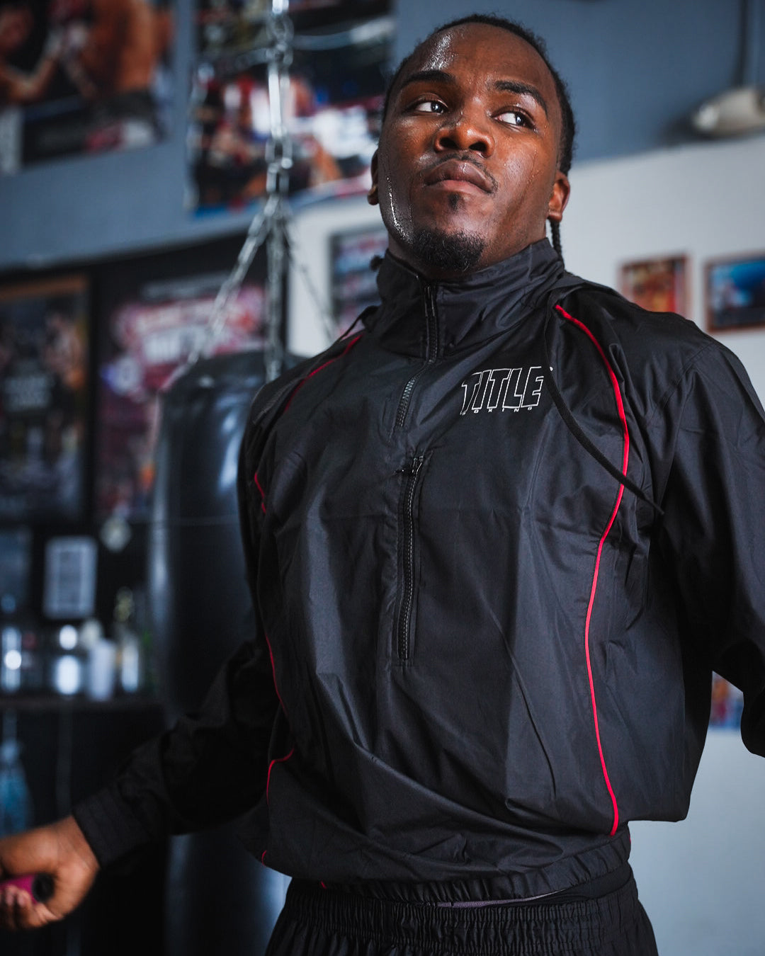 variant:lifestyle::TITLE Boxing Reign Rubberized Sauna Suit on boxer jumping rope in the gym