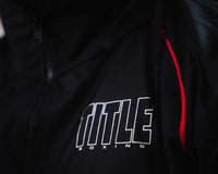 variant:lifestyle::TITLE Boxing Reign Rubberized Sauna Suit closeup of logo on top