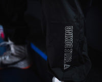 variant:lifestyle::TITLE Boxing Reign Rubberized Sauna Suit closeup of logo on bottom