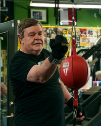 variant:lifestyle::TITLE Boxing Rock Steady Gel Glove Wraps guy hitting speed bag
