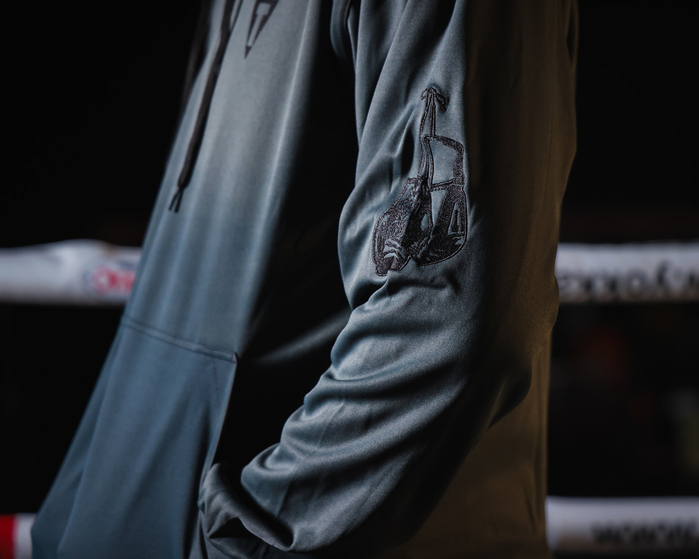 variant:grey/black::TITLE Boxing Thermal Insulated Roadwork Hoodie on athlete closeup of arm logo