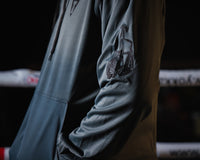 variant:grey/black::TITLE Boxing Thermal Insulated Roadwork Hoodie on athlete closeup of arm logo