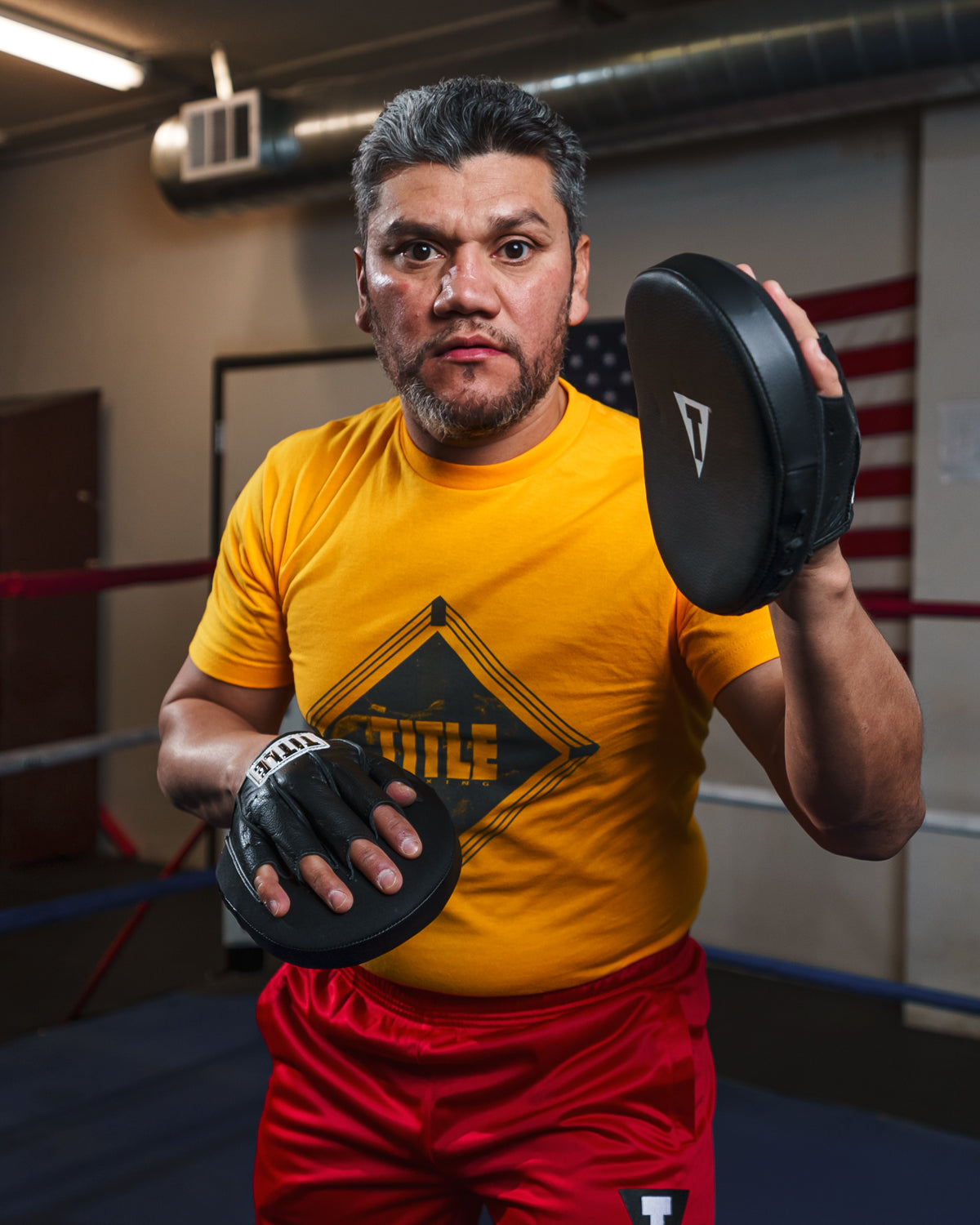 variant:lifestyle::TITLE Boxing Razor Punch Mitts 2.0 guy posing mitts up