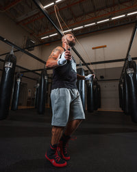 variant:lifestyle::TITLE Classic Leather Speed Rope 2.0 guy holding jump rope guy jumpropes