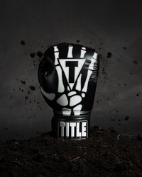 variant:lifestyle::TITLE Boxing Skeleton Hand Bag Gloves single glove view coming out of ground