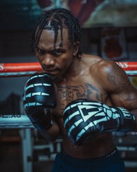 variant:black::TITLE Boxing Skeleton Hand Bag Boxing Gloves on boxer in the ring