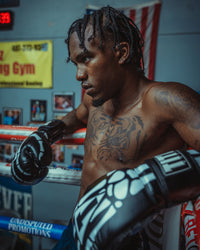 variant:black::TITLE Boxing Skeleton Hand Bag Boxing Gloves on boxer on the  side of a ring