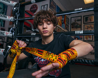 variant:Kente::TITLE Boxing Print Hand Wraps 180" kid putton on wraps over knuckles