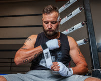 variant:white::TITLE Boxing Select 180" Semi Elastic Mexican Hand Wraps guy putting on wraps