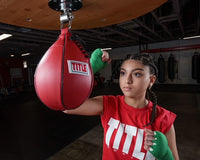 Variant:green::TITLE Boxing Select 180" Semi Elastic Mexican Hand Wraps girl hitting speed bag