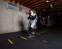 variant:lifestyle::TITLE Boxing Speed & Agility Ladder on the floor of a boxing gym