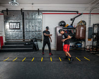 variant:lifestyle::TITLE Boxing Speed & Agility Ladder in use in a boxing gym