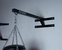 variant:lifestyle::TITLE Boxing Space Saver Wall Mount Bag Hanger 2.0 in use with a heavy bag