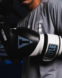 variant:Black/White::TITLE Boxing Swift Bag Boxing Gloves closeup on gloves on fighter's hands