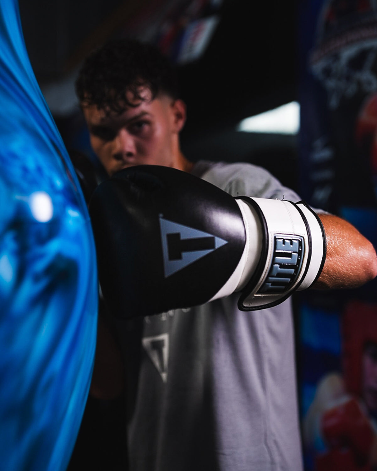 variant:Black/White::TITLE Boxing Swift Bag Boxing Gloves on boxer's hand hitting punching bag closeup