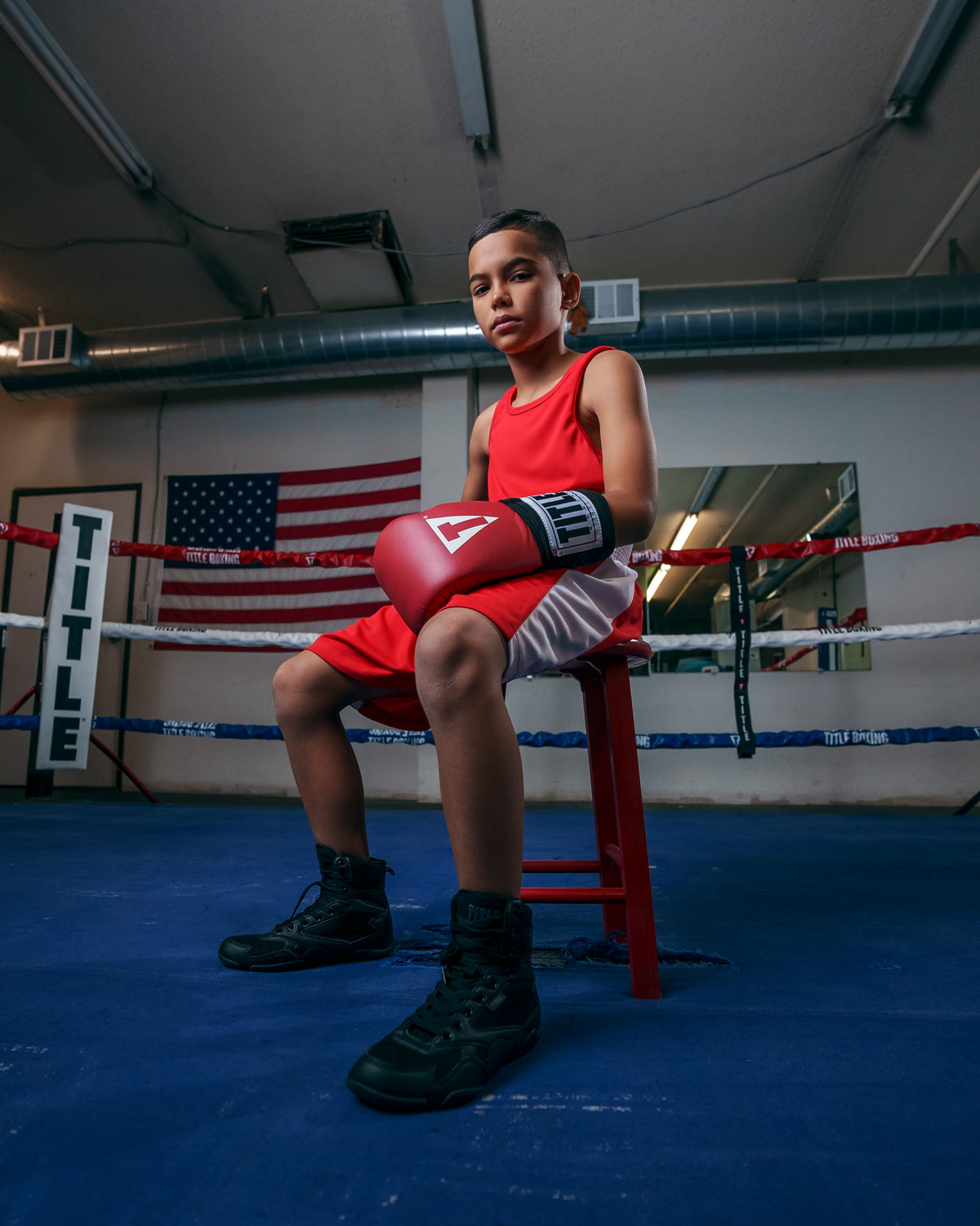 variant:red/white::TITLE Boxing Aerovent Elite Amateur Boxing Set Original 2.0 kid sitting in chair