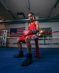 variant:red/white::TITLE Boxing Aerovent Elite Amateur Boxing Set Original 2.0 kid sitting in chair