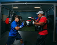 variant:lifestyle::TITLE Boxing Aerovent Excel Incredi-Mitts 2.0 boxer and coach mitting up