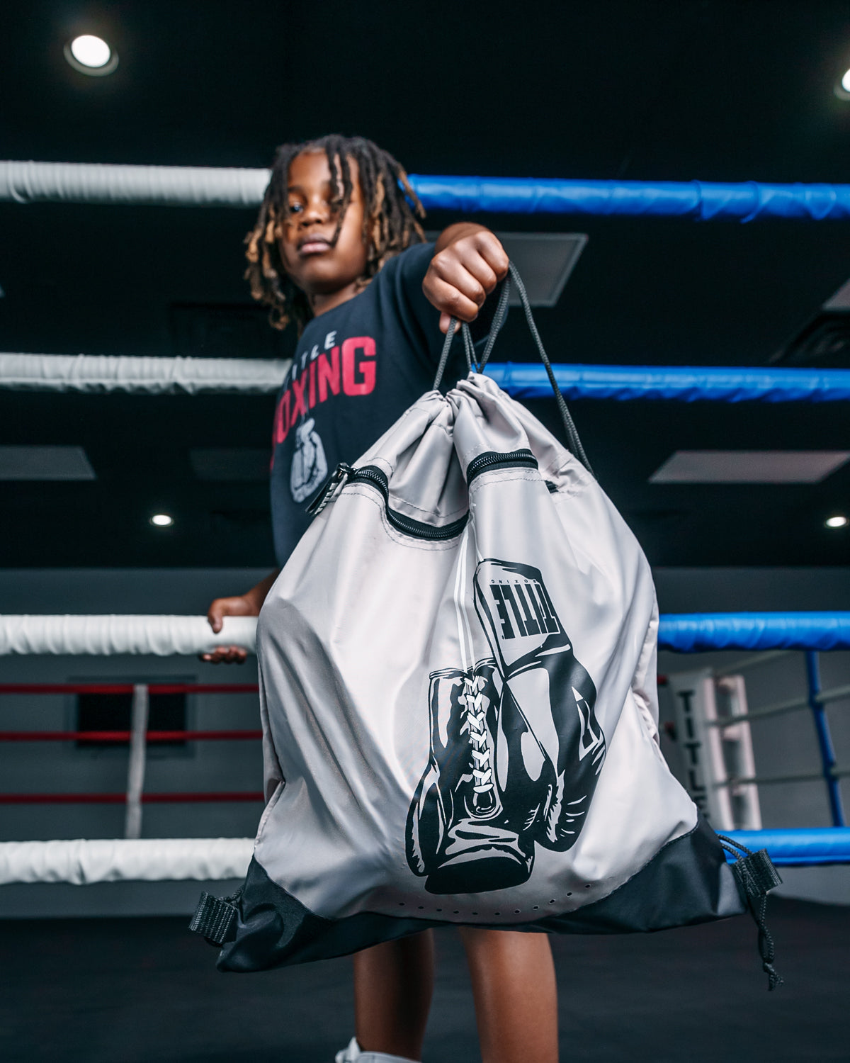 variant:grey::TITLE Boxing Bruiser Gym Sack kid showing off bag
