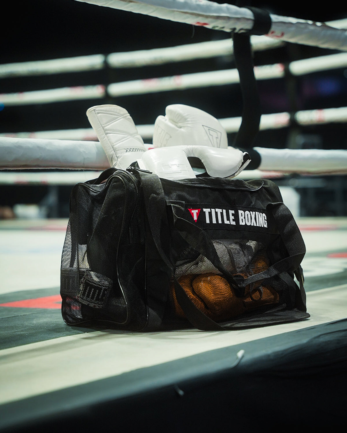 variant:lifestyle::TITLE Boxing Ventilated Sport Bag on side of ring filled with boxing equipment