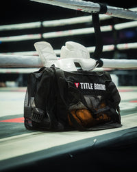 variant:lifestyle::TITLE Boxing Ventilated Sport Bag on side of ring filled with boxing equipment