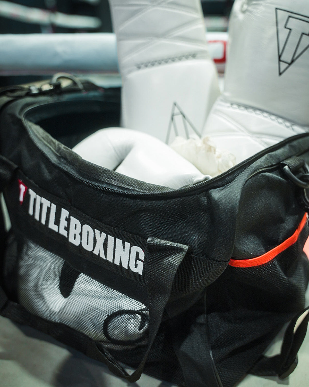 variant:lifestyle::TITLE Boxing Ventilated Sport Bag on side of ring filled with boxing equipment closeup