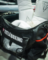 variant:lifestyle::TITLE Boxing Ventilated Sport Bag on side of ring filled with boxing equipment closeup