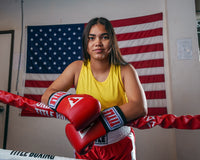 variant:gold::TITLE Boxing Aerovent Elite Racerback Boxing Jersey 2.0 girl on ring ropes