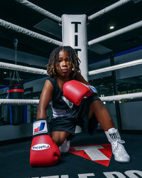 variant:White::TITLE Boxing Speed-Flex Encore Mid-Top Shoes boy kneeling in ring
