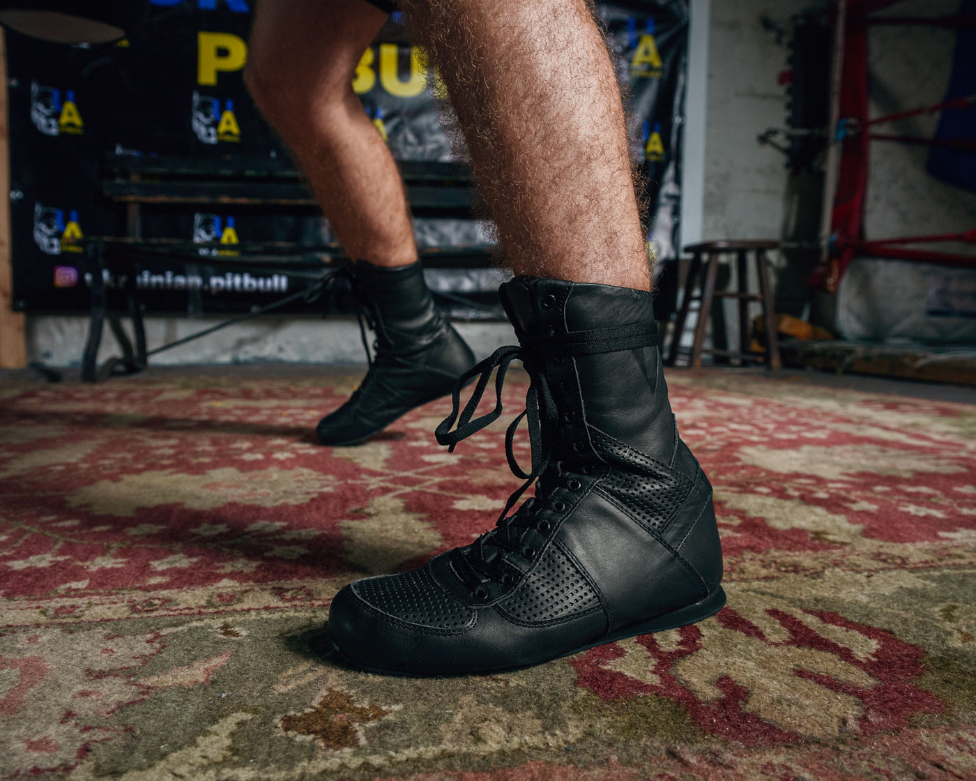 variant:black::TITLE Boxing High-Top Leather Boxing Shoes guy feet on carpet