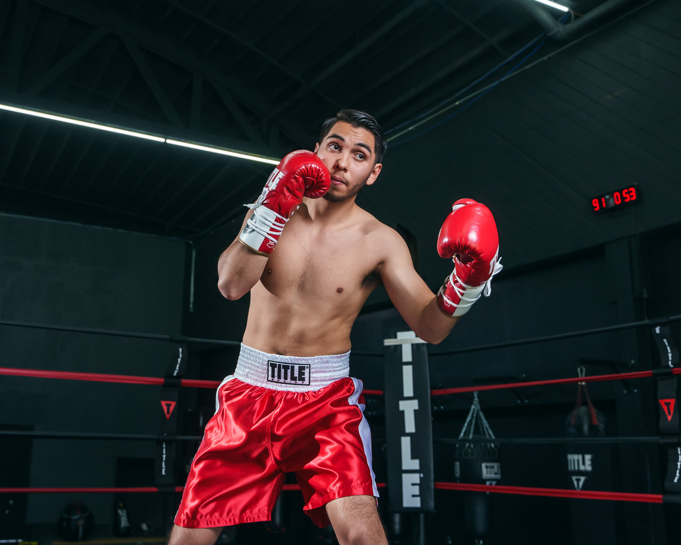 variant:Red/White::TITLE Boxing Edge Boxing Trunks 2.0 guy in a pose wearing trunks