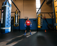 variant:Red/White::TITLE Boxing Iconic Block Muscle Tee boy posing between three bags