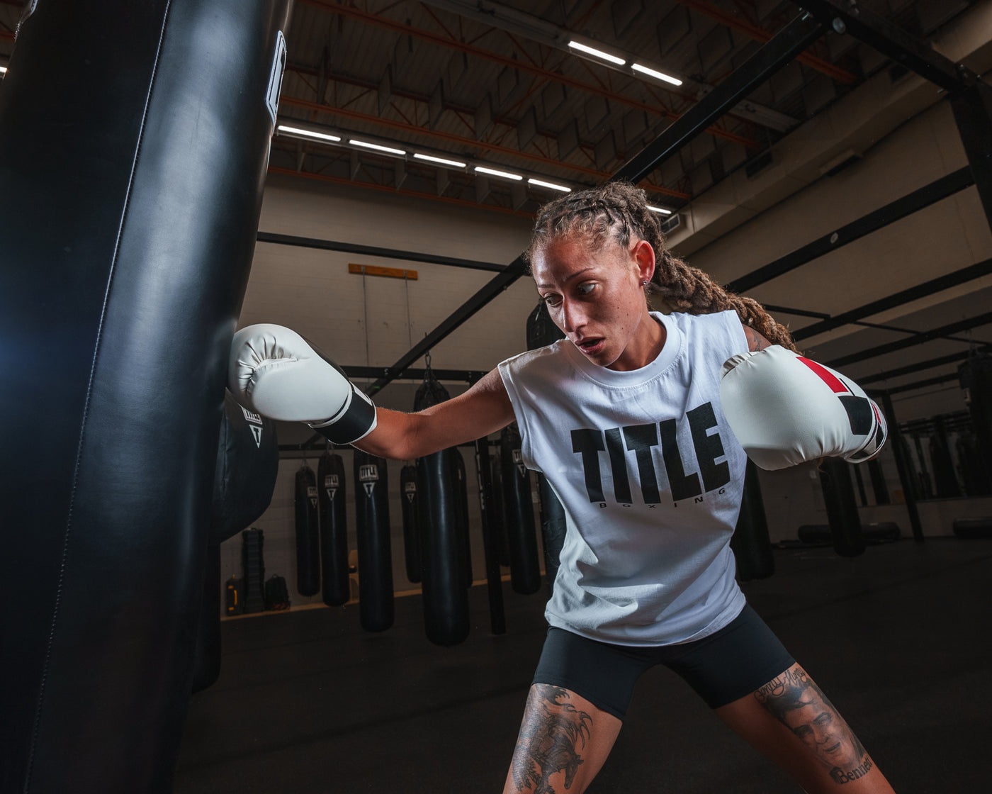 variant:White::TITLE Boxing Iconic Block Muscle Tee girl hitting bag