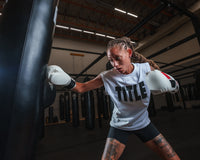 variant:White::TITLE Boxing Iconic Block Muscle Tee girl hitting bag