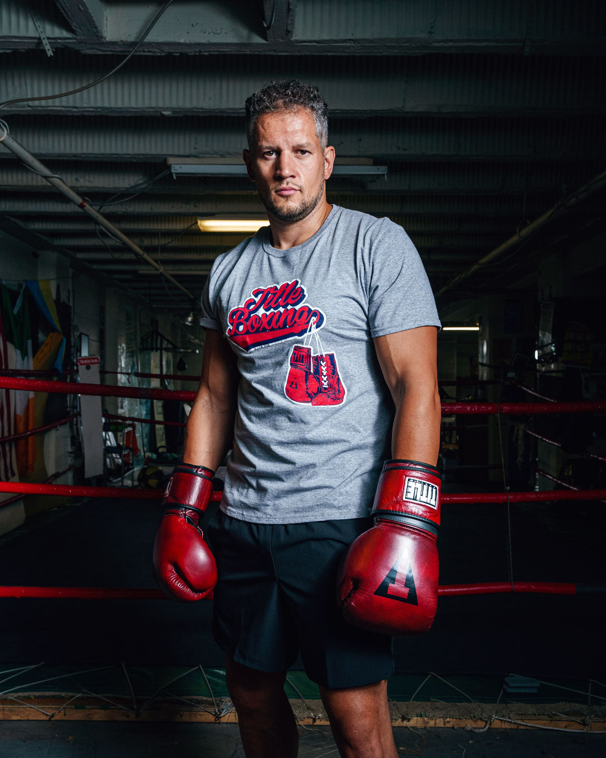 variant:grey::TITLE Boxing Classic Script Performance Tee man infront of ring