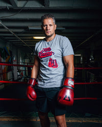 variant:grey::TITLE Boxing Classic Script Performance Tee man infront of ring