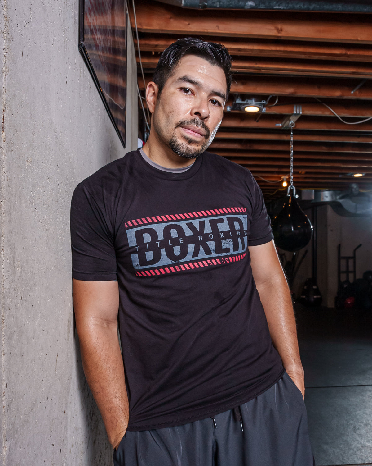 variant:Black::TITLE Boxing Distressed Boxer Tee guy posing against the wall