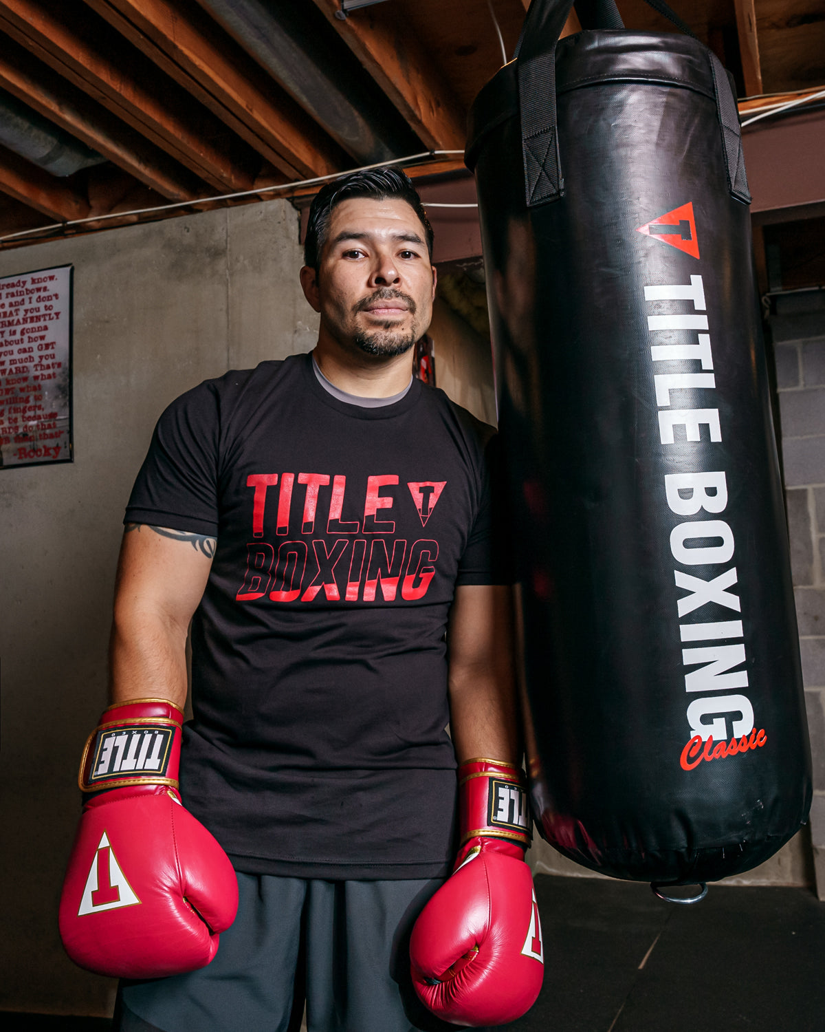 variant:Black::TITLE Boxing Upsurge Tee guy posing against a bag