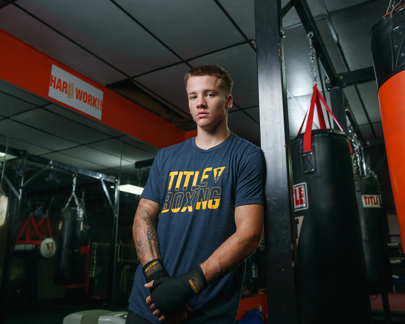 variant:Navy::TITLE Boxing Upsurge Tee guy posing against a bag