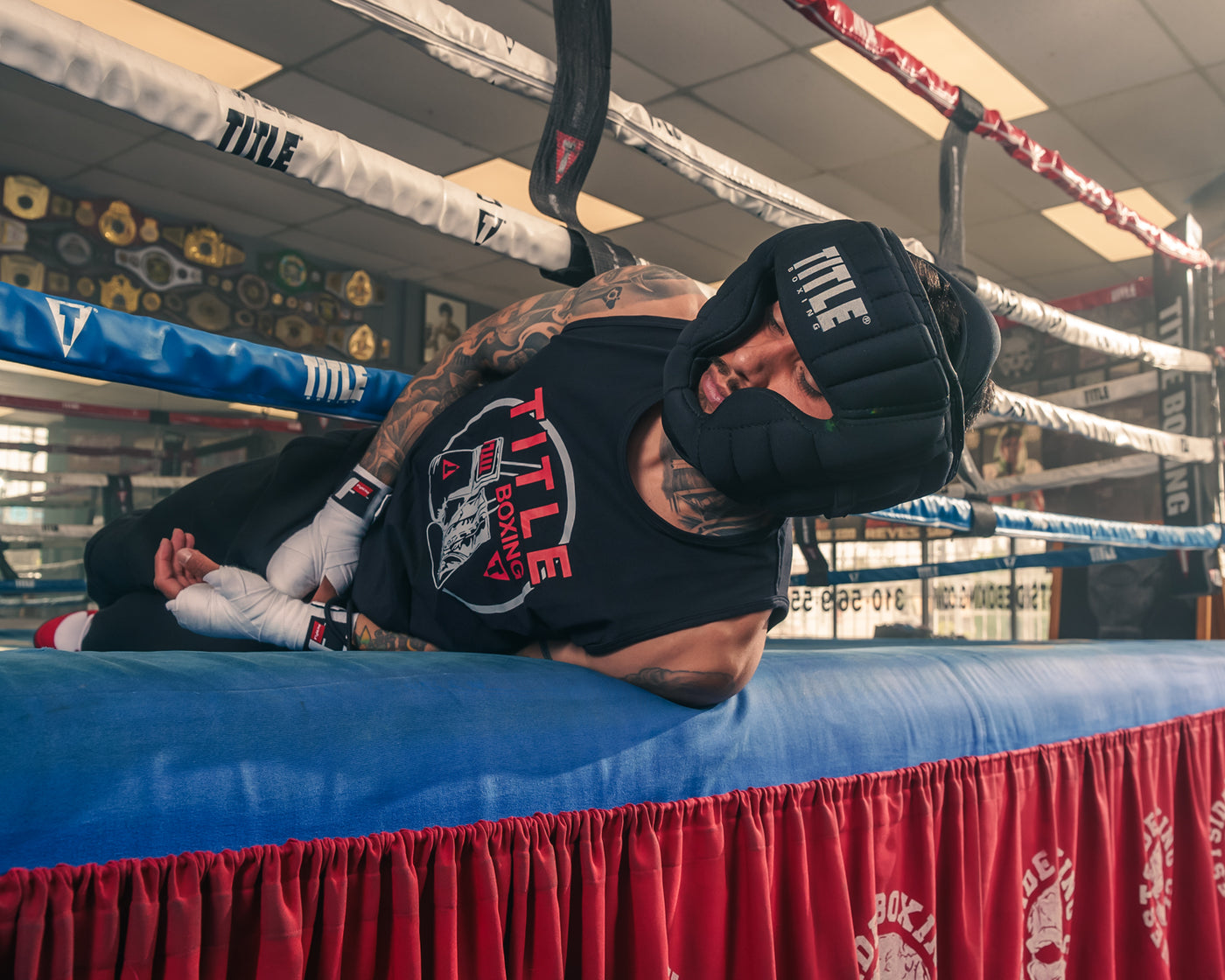 variant:lifestyle::TITLE Boxing Weighted Headgear guy doing neck exercise on ring
