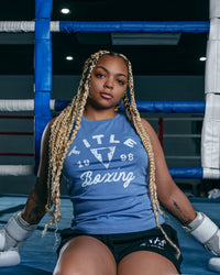 variant:blue::TITLE Boxing Women's Distressed Label Muscle Tank girl sitting on ring
