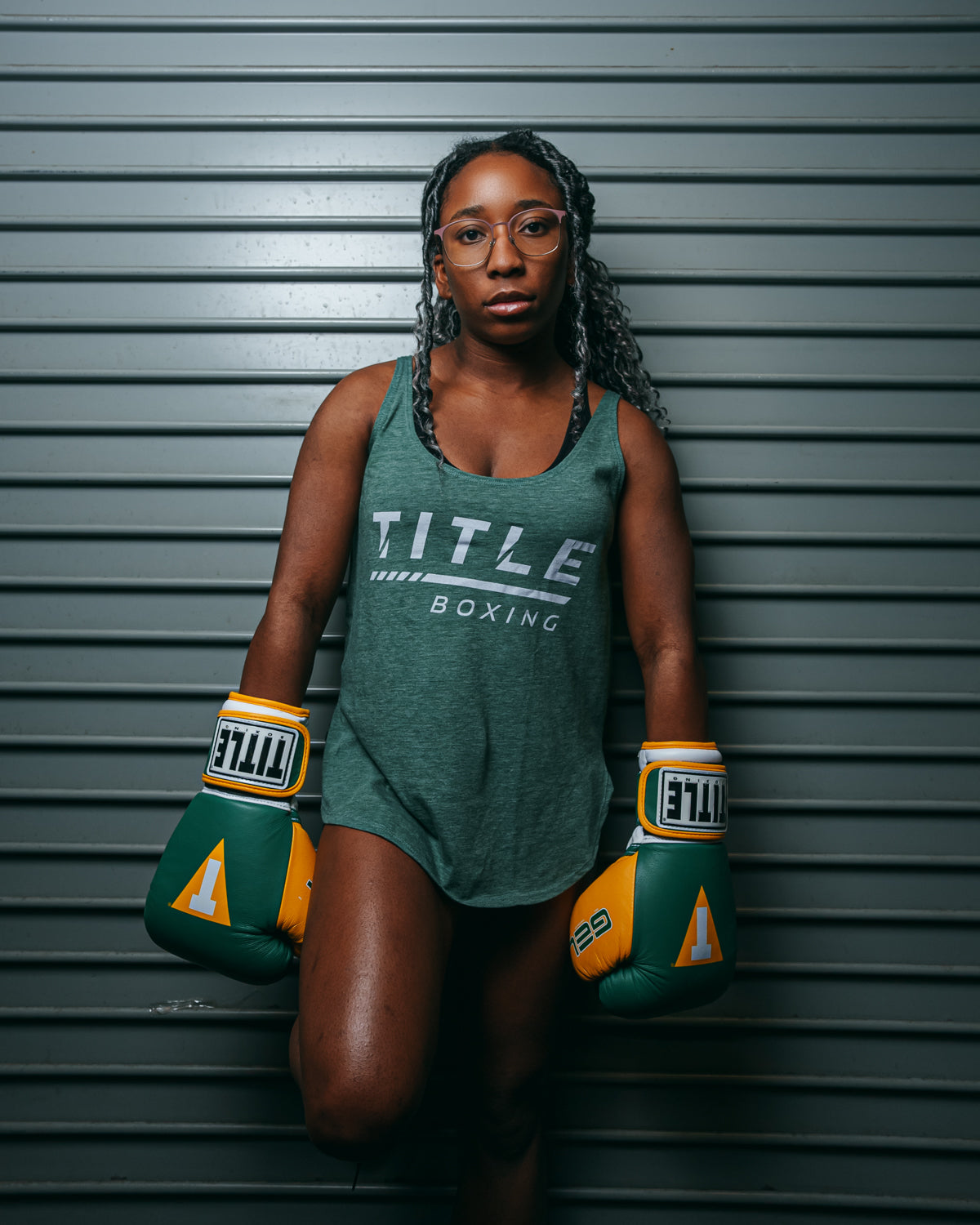 variant:green::TITLE Boxing Women's Striped Wordmark Cropped Tankgirl on wall
