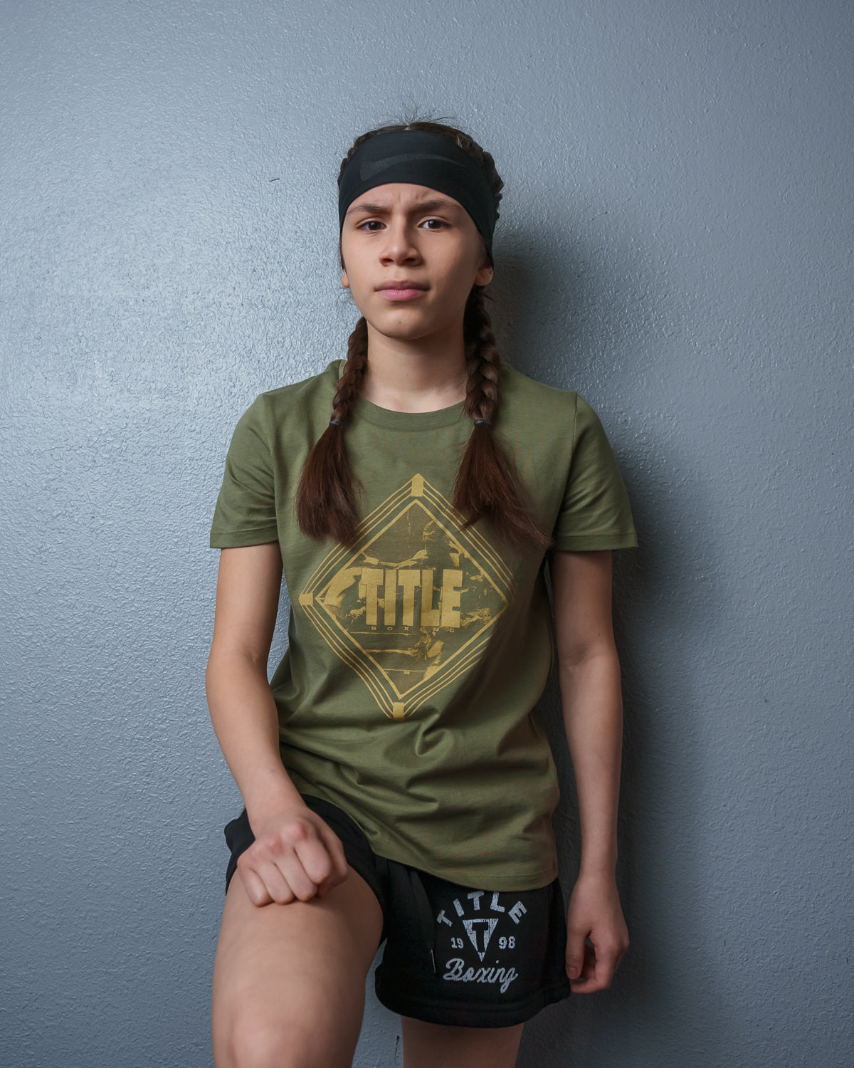 variant:green::TITLE Boxing Women's Snapshot tee girl standing on wall