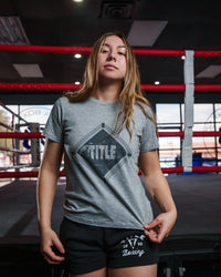 variant:grey::TITLE Boxing Women's Snapshot tee girl standing infront of ring