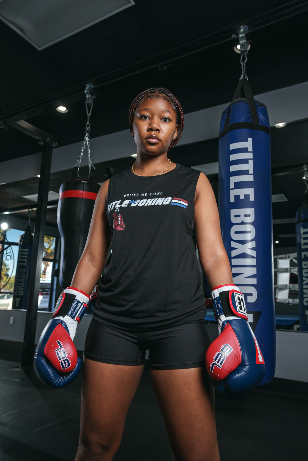 variant:Black::TITLE Boxing United Women's Tank girl hands down infront of blue bag
