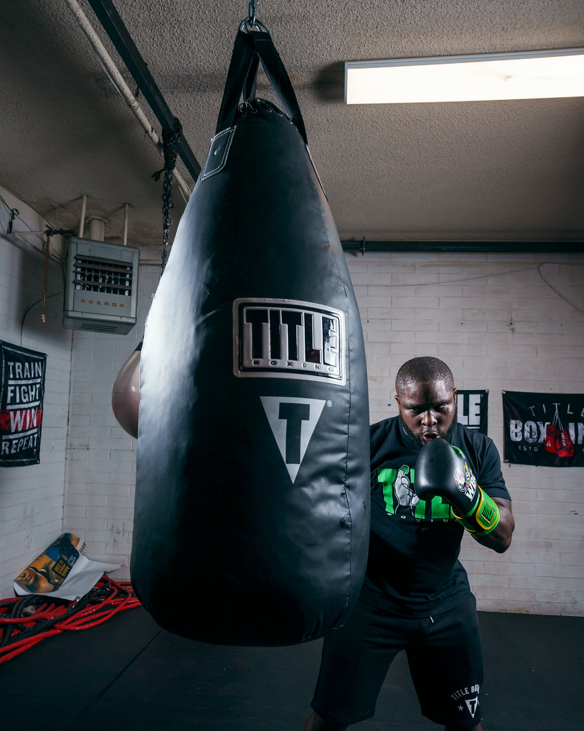 variant:Lifestyle::TITLE Boxing Tear Drop Heavy Bag guy front view hitting bag