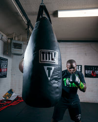 variant:Lifestyle::TITLE Boxing Tear Drop Heavy Bag guy front view hitting bag