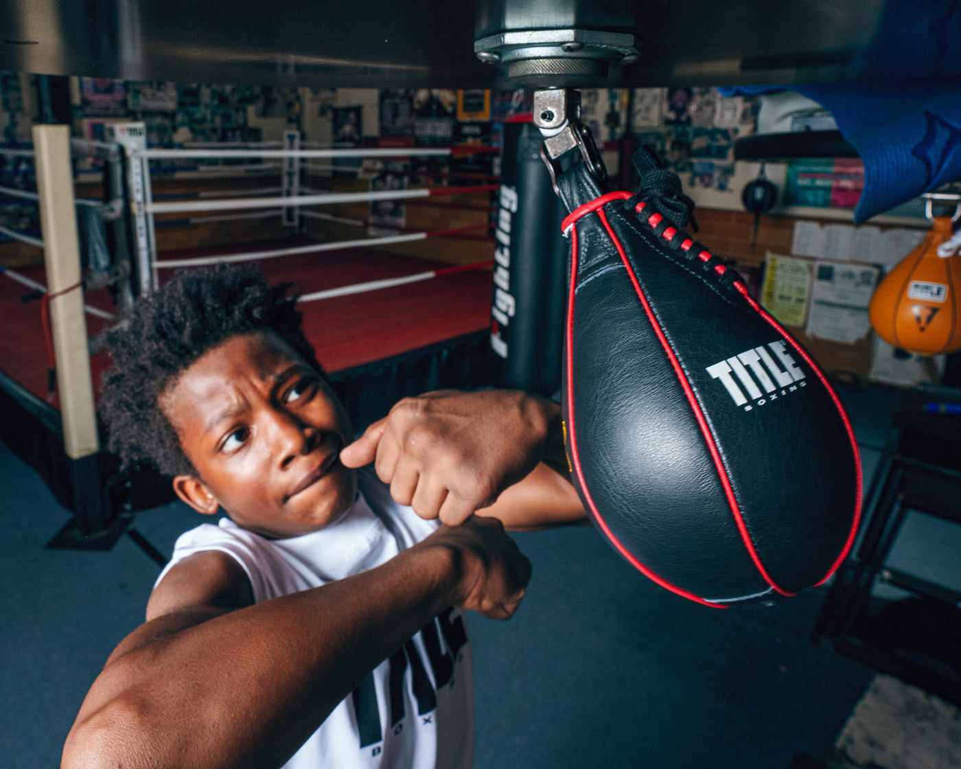 variant:lifestyle::TITLE Boxing Gyro Balanced Leather Speed Bag kid hitting bag from the top photo