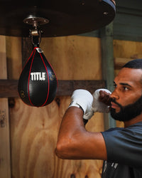 variant:lifestyle::TITLE Boxing Gyro Balanced Leather Speed Bag 2.0 being hit in the gym